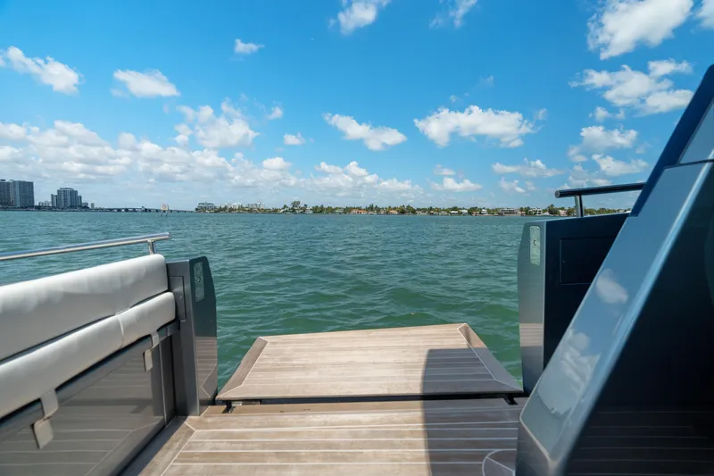 Pura Vida Yacht Photos Pics 2024 CNM CONTINENTAL 54 SuperSport yacht deck with ocean view under blue sky.