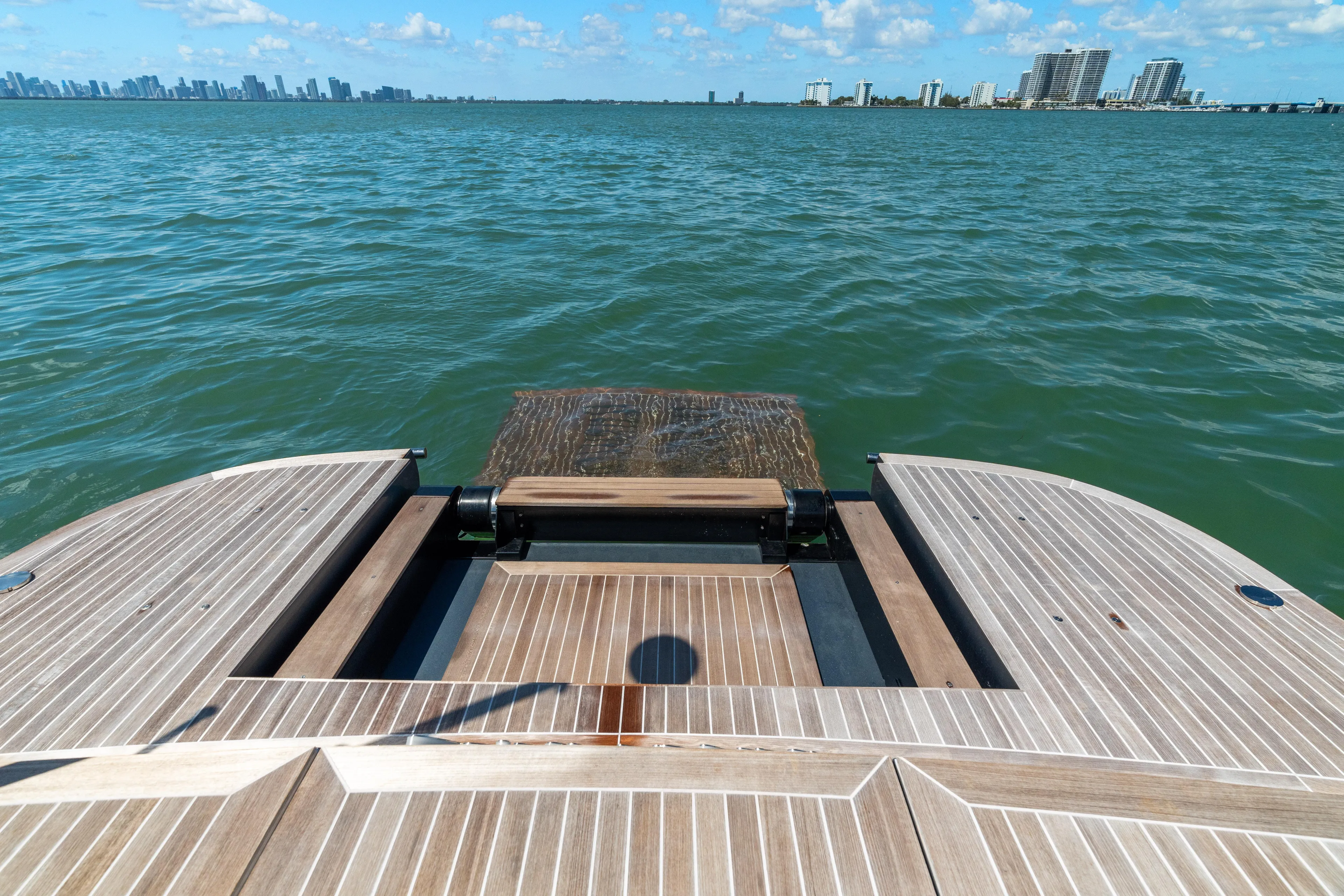 Pura Vida Yacht Photos Pics 2024 CNM CONTINENTAL 54 SuperSport yacht deck overlooking ocean and city skyline.