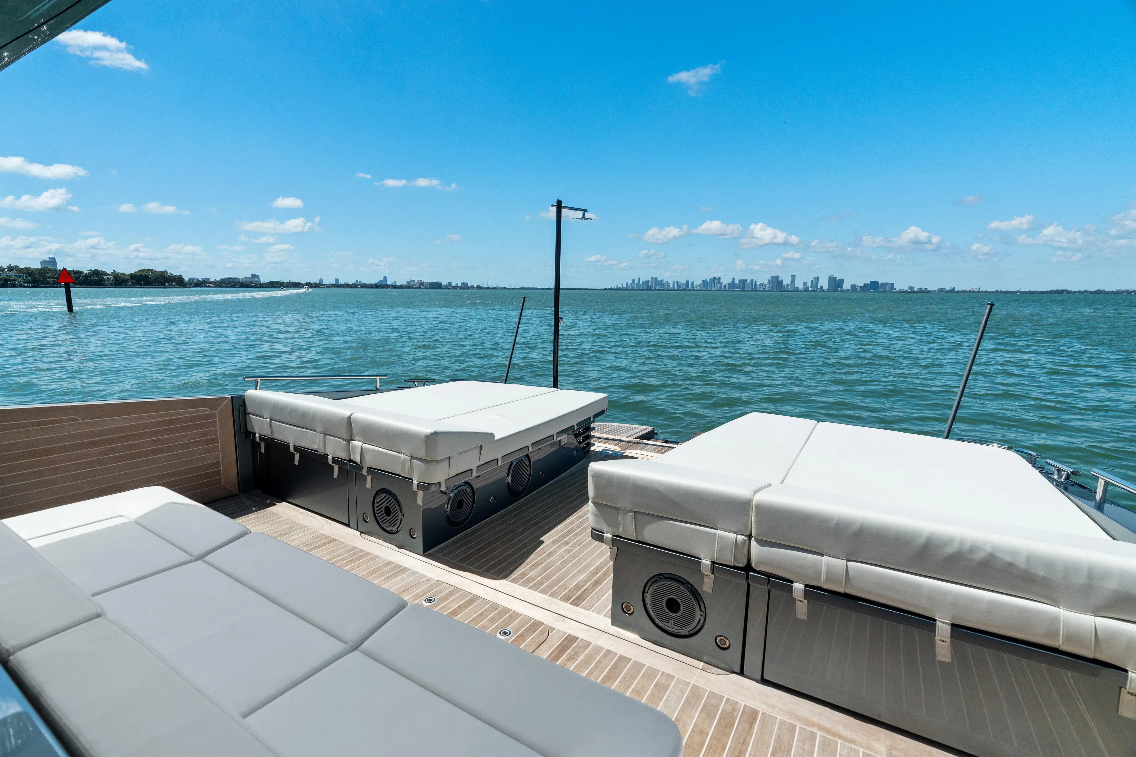 Pura Vida Yacht Photos Pics 2024 CNM CONTINENTAL 54 SuperSport yacht deck with sunbeds, overlooking serene ocean view.