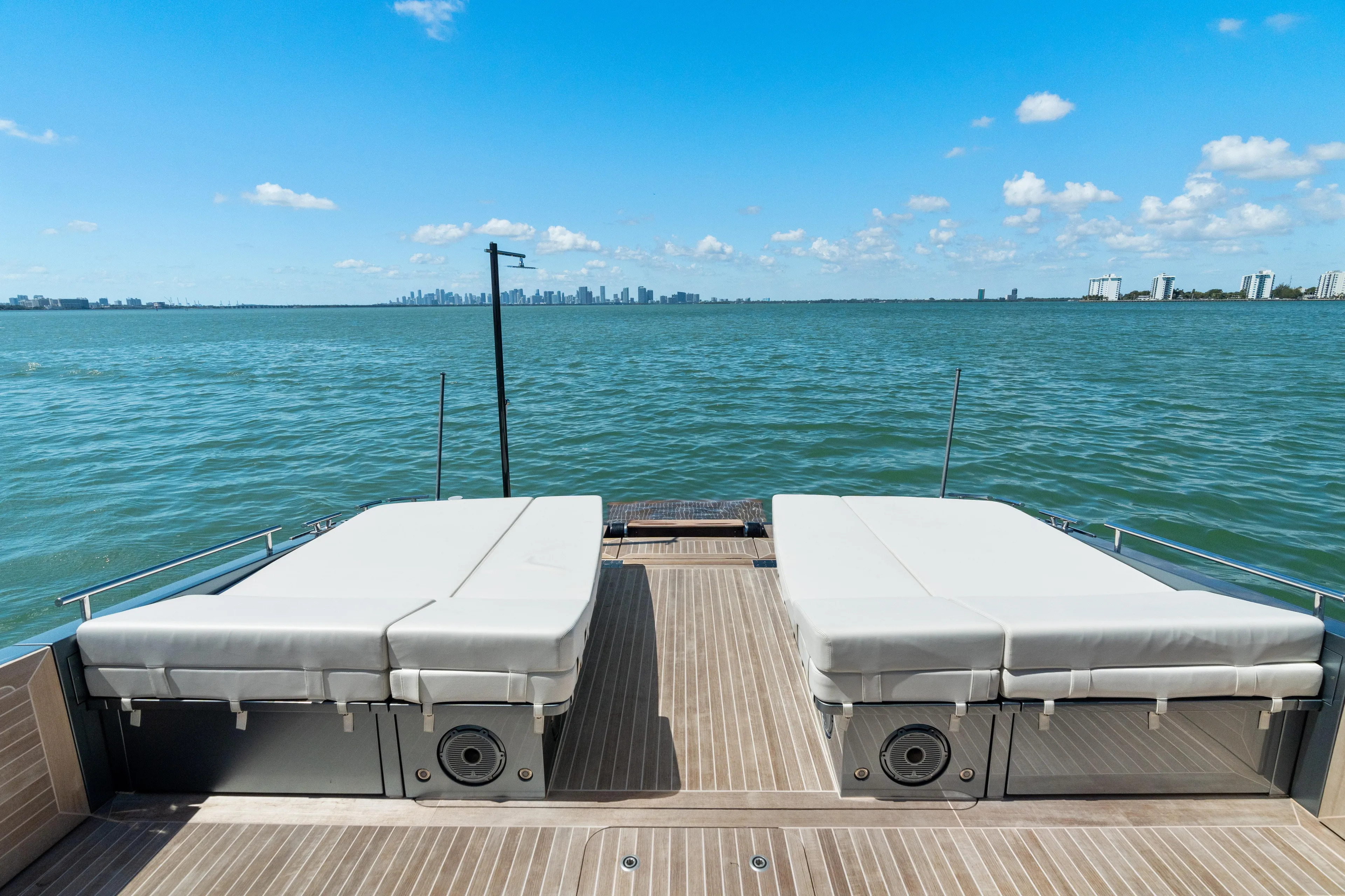 Pura Vida Yacht Photos Pics 2024 CNM CONTINENTAL 54 SuperSport yacht deck with sunbeds overlooking ocean.