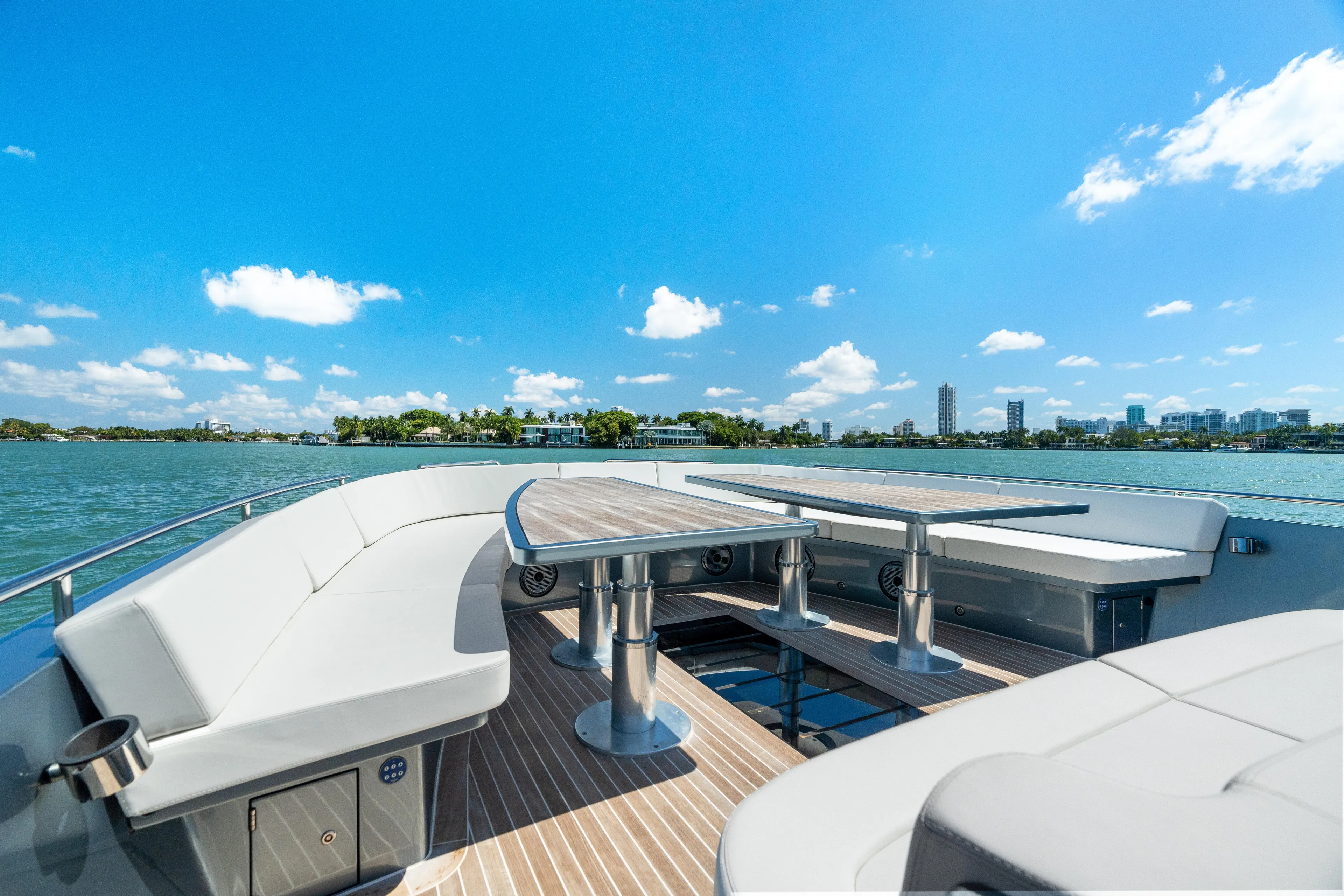 Pura Vida Yacht Photos Pics Luxurious 2024 CNM CONTINENTAL 54 SuperSport yacht deck with scenic waterfront view.