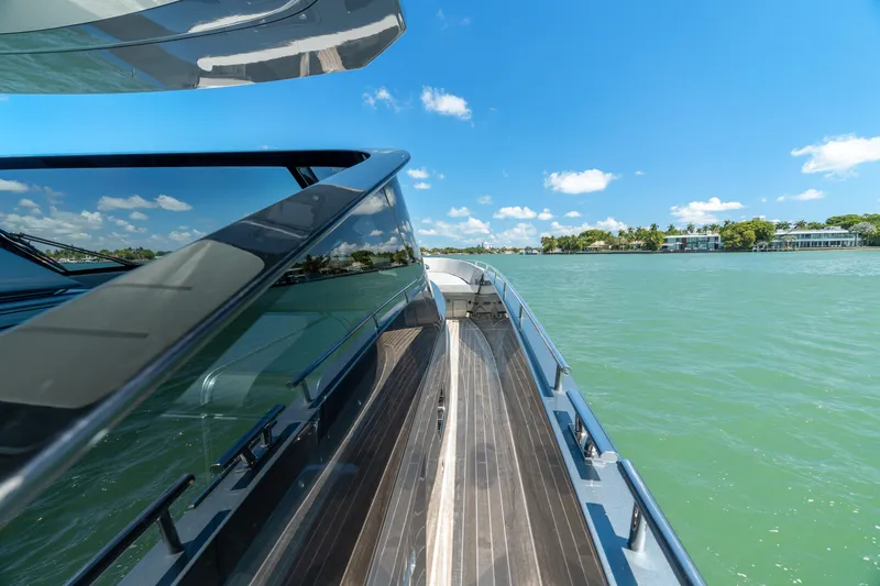Pura Vida Yacht Photos Pics 2024 CNM CONTINENTAL 54 SuperSport yacht on serene water under clear blue sky.