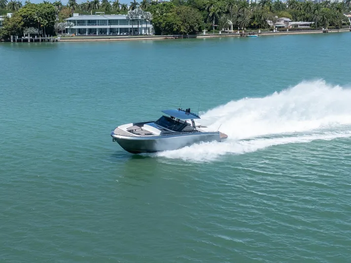 Pura Vida Yacht Photos Pics 2024 CNM CONTINENTAL 54 SuperSport yacht speeding on a serene waterway.