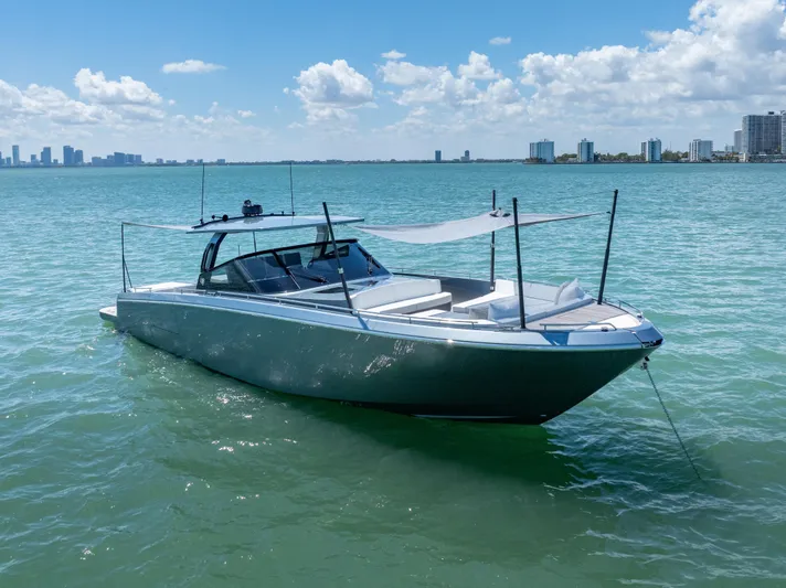 Pura Vida Yacht Photos Pics 2024 CNM CONTINENTAL 54 SuperSport yacht on calm water, city skyline in background.