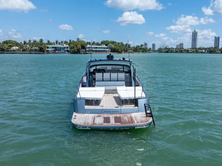 Pura Vida Yacht Photos Pics 2024 CNM CONTINENTAL 54 SuperSport yacht on calm water, city skyline in background.