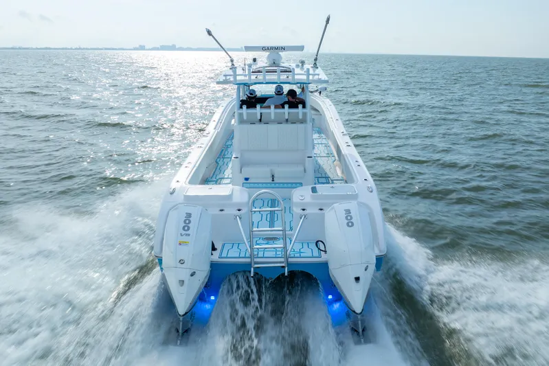  Yacht Photos Pics 2025 Insetta 35IFC boat cruising on open water, rear view with dual engines.