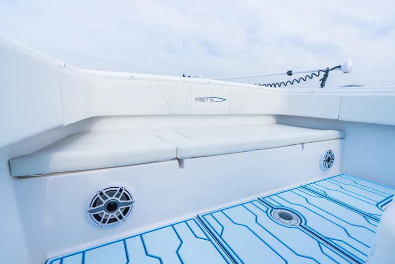  Yacht Photos Pics 2025 Insetta 35IFC boat interior with white seating and blue-accented flooring.