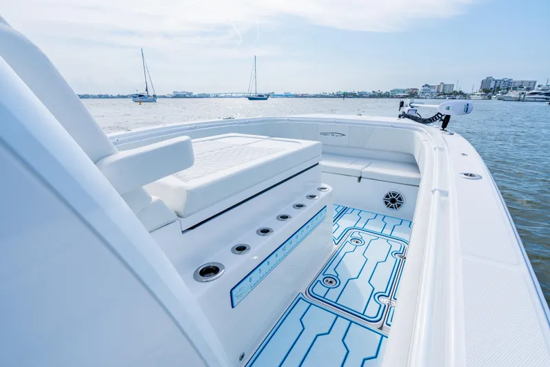  Yacht Photos Pics 2025 Insetta 35IFC boat interior with seating, rod holders, and blue deck design on calm water.