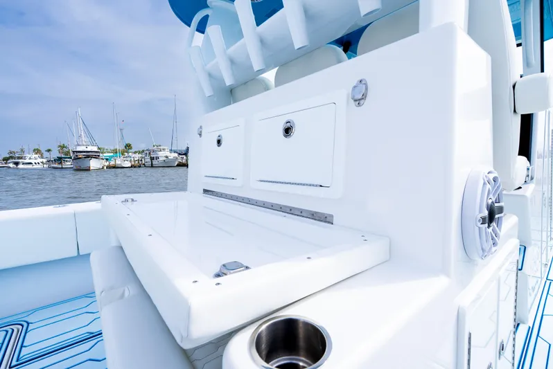  Yacht Photos Pics 2025 Insetta 35IFC boat interior with storage compartments and cup holder, docked at marina.