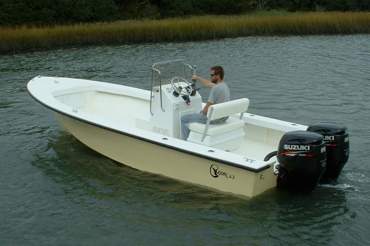 Manufacturer Provided Image: 2026 C-Hawk 23 Center Console boat with dual Suzuki engines on a calm waterway.