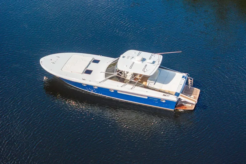Prana Yacht Photos Pics Aerial view of a 1995 Itama 46 yacht cruising on calm blue waters.