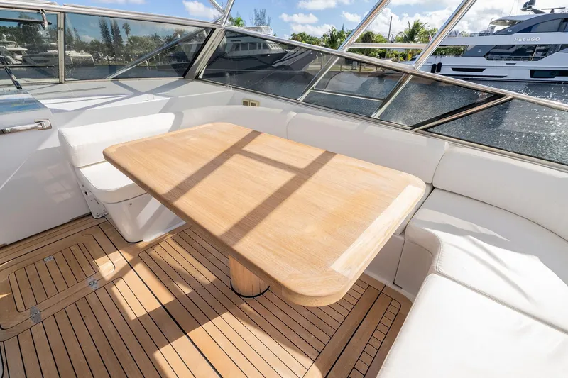 Prana Yacht Photos Pics Luxurious Itama 46 yacht interior with wooden table and white seating, 1995 model.