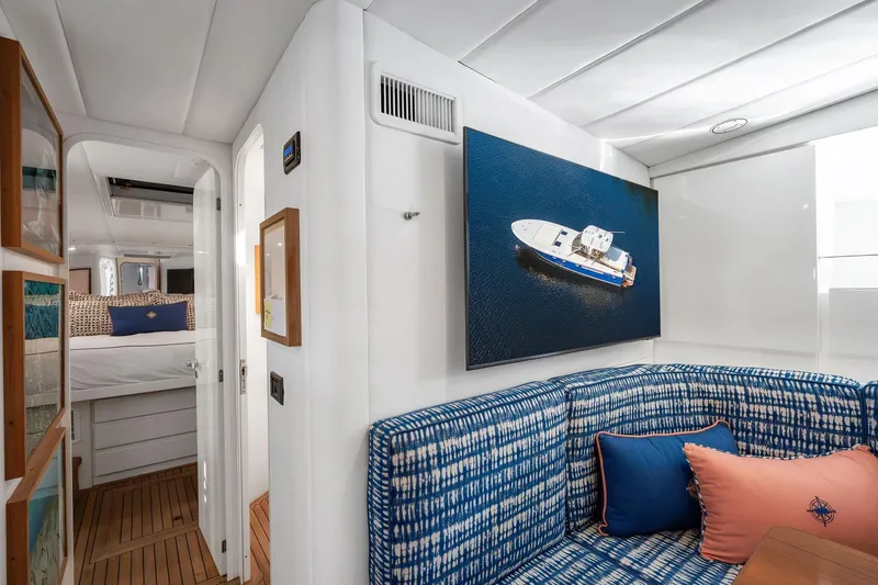 Prana Yacht Photos Pics Luxurious interior of a 1995 Itama 46 yacht with blue patterned seating and nautical decor.