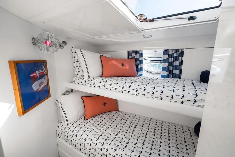 Prana Yacht Photos Pics Cozy cabin interior of 1995 Itama 46 yacht with nautical-themed bunk beds.