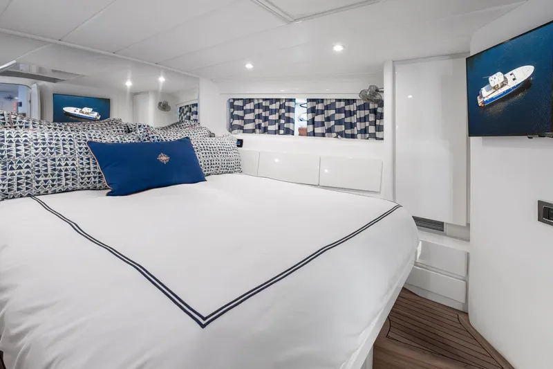 Prana Yacht Photos Pics Luxurious cabin interior of a 1995 Itama 46 yacht with elegant bedding and modern decor.