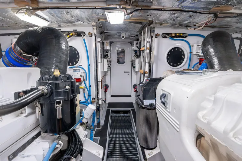 Prana Yacht Photos Pics Engine room of a 1995 Itama 46 yacht, featuring mechanical components and piping.