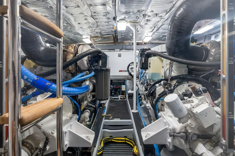 Prana Yacht Photos Pics Engine room of a 1995 Itama 46 yacht, featuring complex machinery and piping.