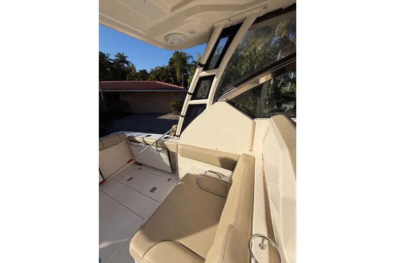  Yacht Photos Pics 2017 Pursuit DC 295 Dual Console interior with beige seating and windows.