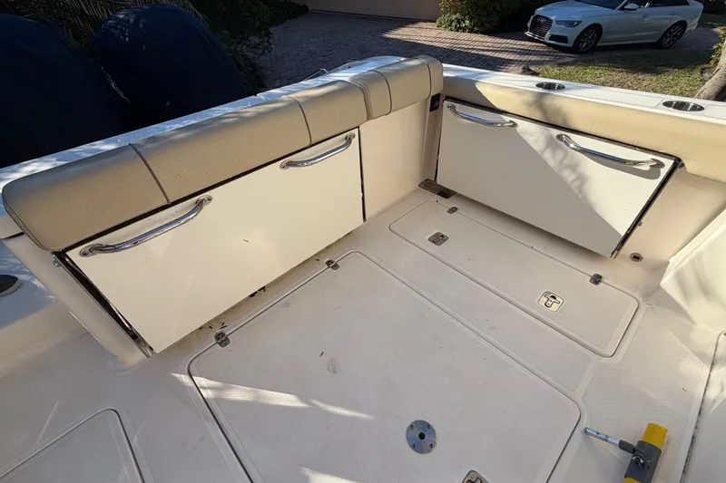  Yacht Photos Pics 2017 Pursuit DC 295 Dual Console boat interior with storage compartments and cushioned seating.