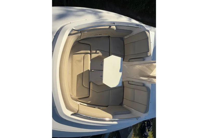  Yacht Photos Pics 2017 Pursuit DC 295 Dual Console boat interior with beige seating and table.