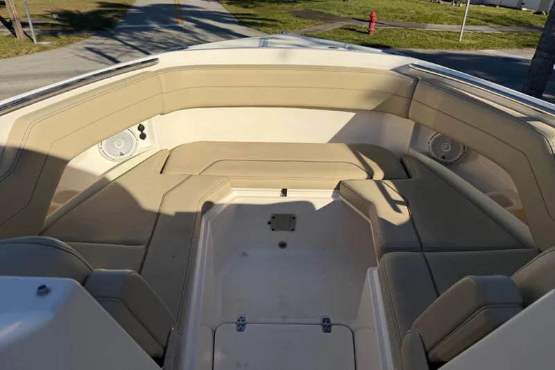  Yacht Photos Pics 2017 Pursuit DC 295 Dual Console boat interior with beige seating and speakers.