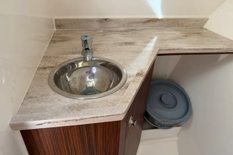  Yacht Photos Pics 2017 Pursuit DC 295 Dual Console boat interior with sink and countertop.