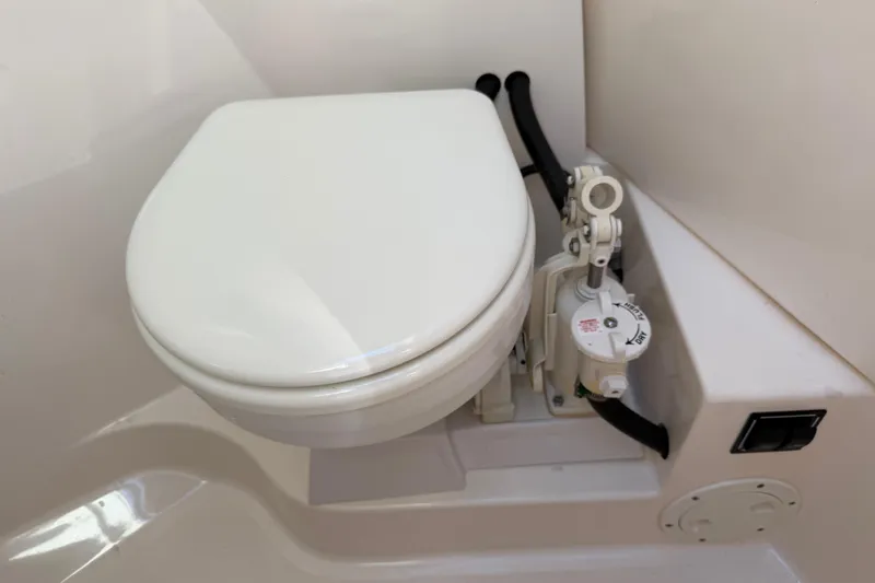  Yacht Photos Pics 2017 Pursuit DC 295 Dual Console marine toilet with manual pump system.