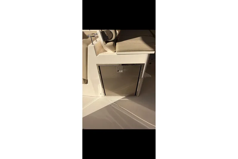  Yacht Photos Pics 2017 Pursuit DC 295 Dual Console interior with built-in storage compartment.