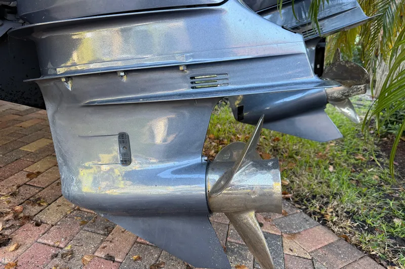  Yacht Photos Pics 2017 Pursuit DC 295 Dual Console boat propellers on a brick driveway.