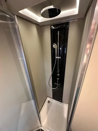  Yacht Photos Pics Modern shower in 2022 Azimut Atlantis 51 yacht, featuring sleek design and overhead rain shower.