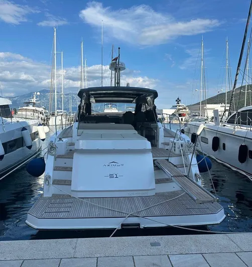  Yacht Photos Pics 2022 Azimut Atlantis 51 yacht docked in a marina under a blue sky.