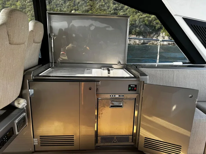  Yacht Photos Pics Modern kitchenette on 2022 Azimut Atlantis 51 yacht with stainless steel sink and mini fridge.