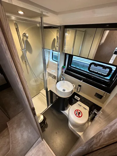  Yacht Photos Pics Luxurious bathroom in 2022 Azimut Atlantis 51 yacht, featuring modern shower and sleek fixtures.