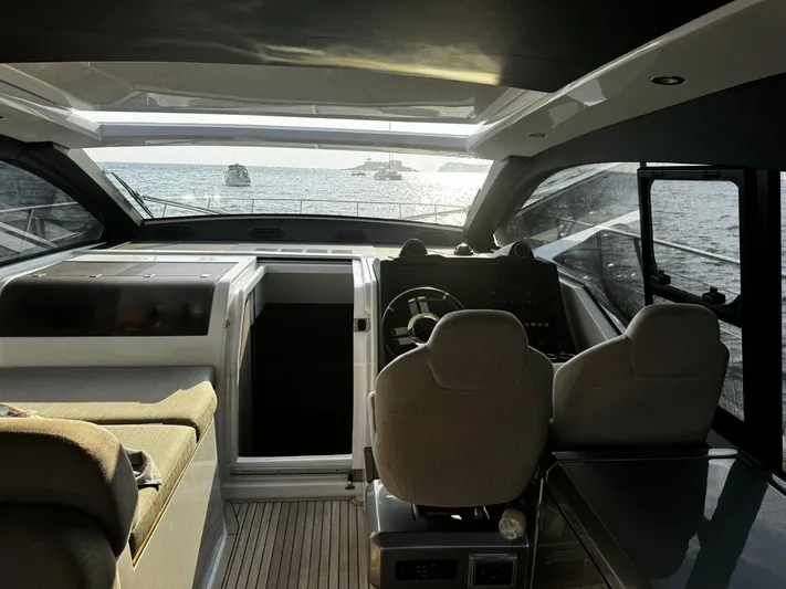  Yacht Photos Pics Interior view of 2022 Azimut Atlantis 51 yacht cockpit with ocean backdrop.