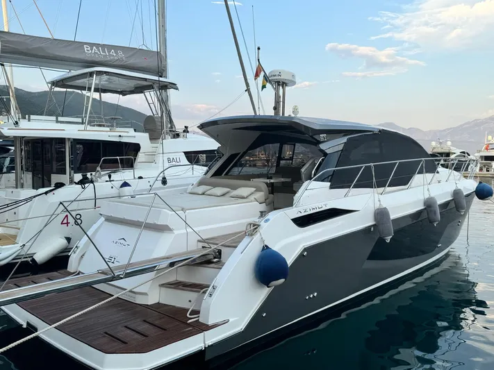  Yacht Photos Pics 2022 Azimut Atlantis 51 yacht docked in marina, featuring sleek design and luxurious amenities.