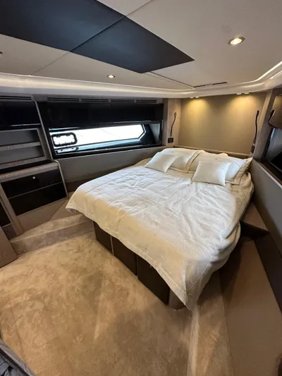  Yacht Photos Pics Luxurious bedroom interior of 2022 Azimut Atlantis 51 yacht with modern design and cozy bedding.