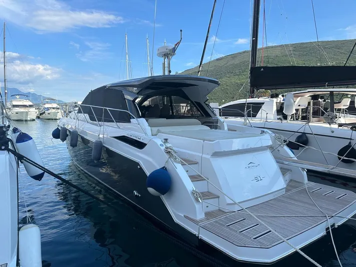  Yacht Photos Pics 2022 Azimut Atlantis 51 yacht docked in a marina, surrounded by other boats.