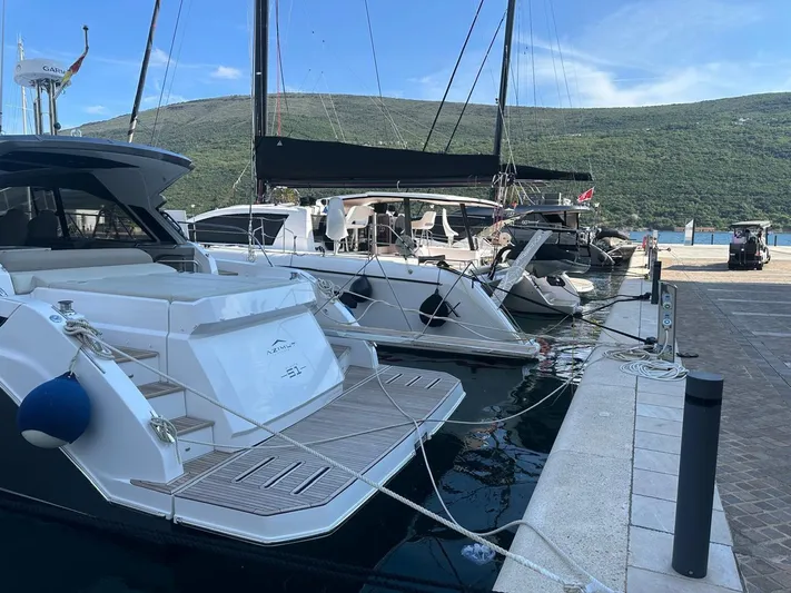  Yacht Photos Pics Azimut Atlantis 51 yacht docked at marina, 2022 model, scenic mountain backdrop.