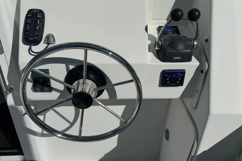  Yacht Photos Pics Steering wheel and controls of a 2005 Ocean Sport Roamer 30 boat.