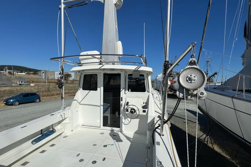  Yacht Photos Pics 2005 Ocean Sport Roamer 30 boat on land, showcasing deck and cabin area.