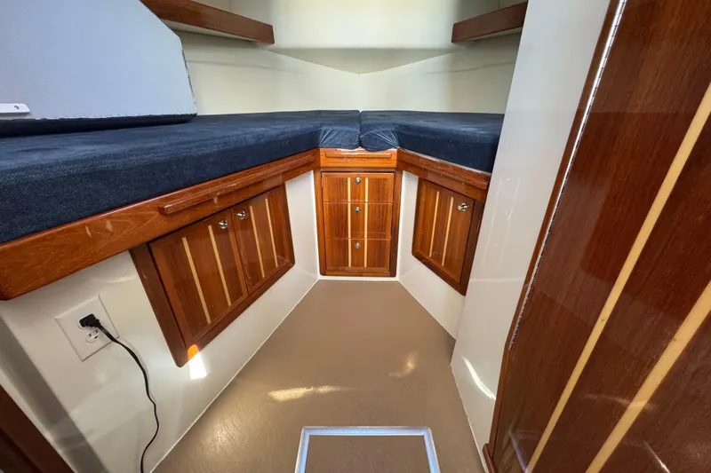  Yacht Photos Pics Interior cabin of 2005 Ocean Sport Roamer 30 with wooden storage and seating.