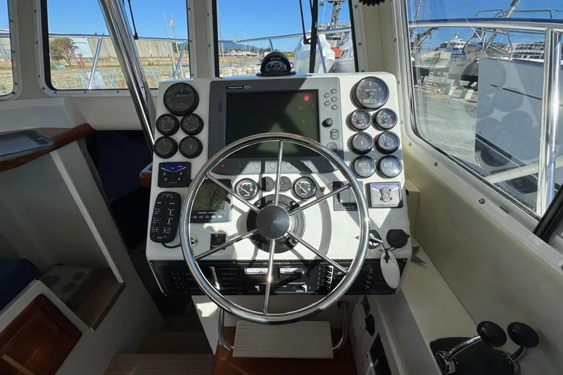  Yacht Photos Pics Helm of 2005 Ocean Sport Roamer 30 with navigation instruments and steering wheel.