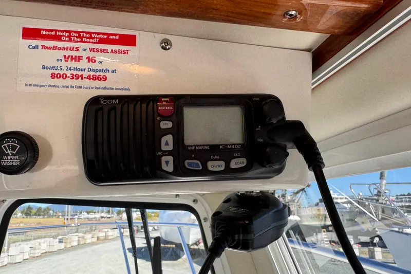  Yacht Photos Pics VHF radio on 2005 Ocean Sport Roamer 30 boat, with emergency contact information displayed.