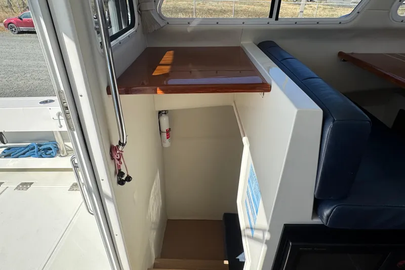  Yacht Photos Pics Interior view of 2005 Ocean Sport Roamer 30 boat with seating and stairs.