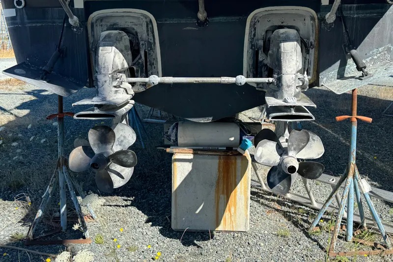  Yacht Photos Pics 2005 Ocean Sport Roamer 30 boat propellers and outdrives on stands, outdoor setting.