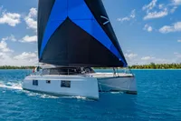 2021 Nautitech 40 Open catamaran sailing in clear blue waters under a sunny sky.