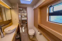Luxurious bathroom interior of 2021 Nautitech 40 Open yacht, featuring modern fixtures and wood accents.