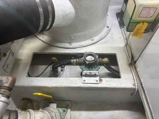 Dry-hydro Yacht Photos Pics Engine compartment of a 1990 Viking Convertible boat, featuring mechanical components and hoses.