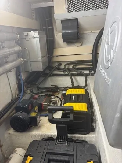 Dry-hydro Yacht Photos Pics Engine room of a 1990 Viking Convertible boat with various mechanical components.