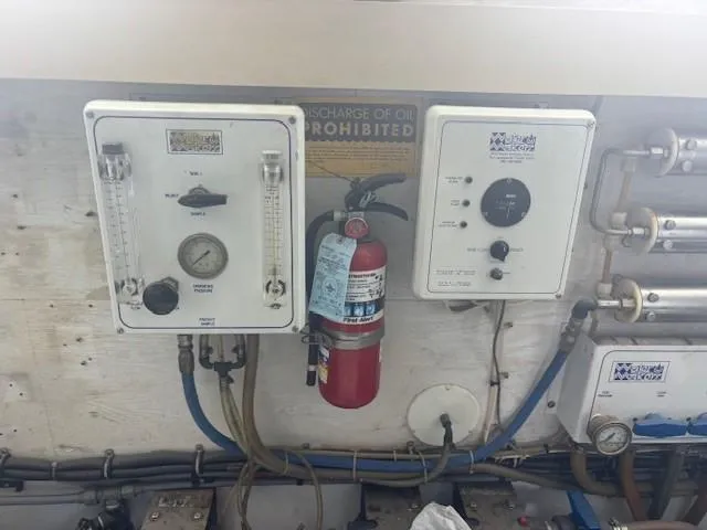 Dry-hydro Yacht Photos Pics Control panel and fire extinguisher in 1990 Viking Convertible boat engine room.